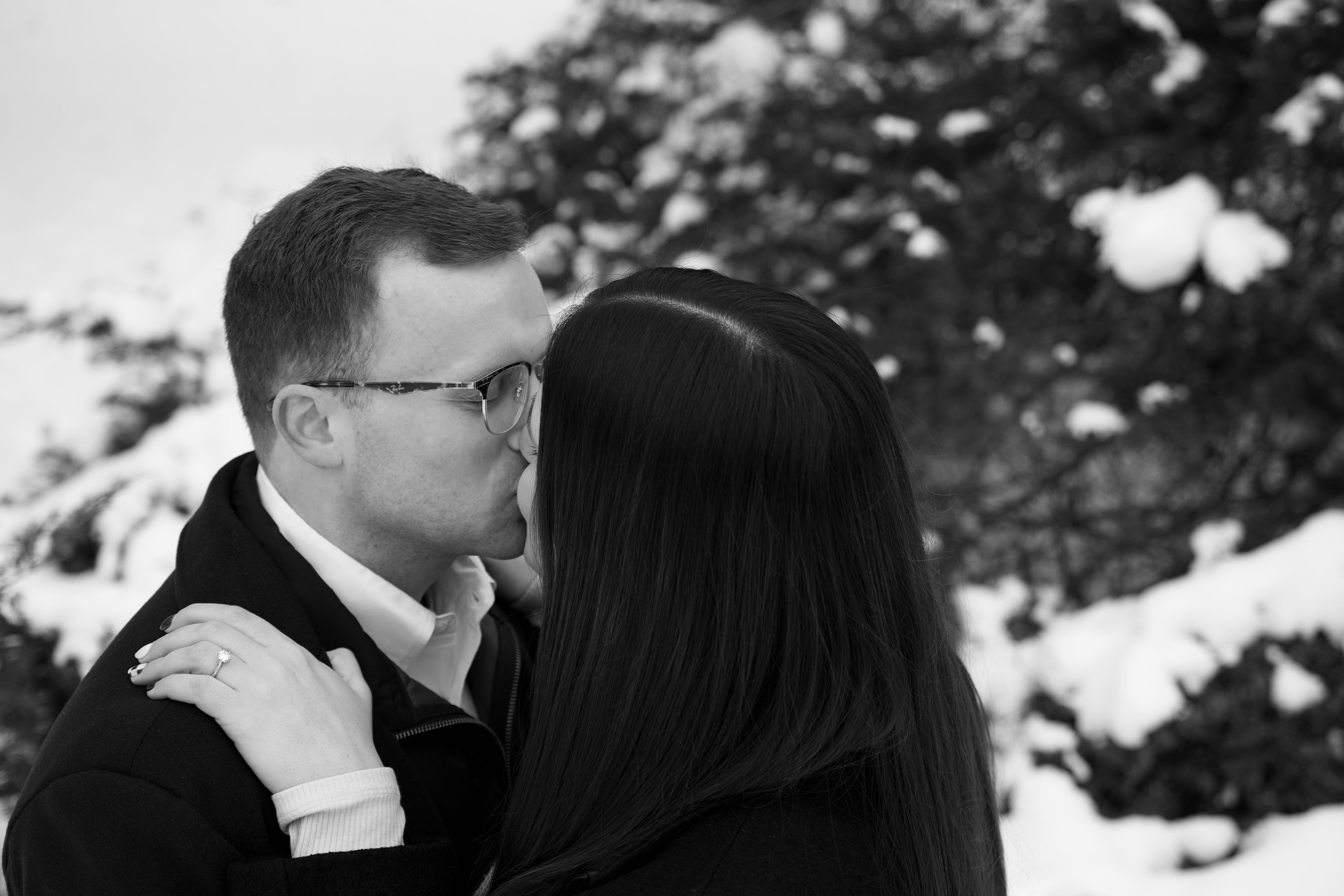Couple in winter clothes in snow for a perfect proposal 