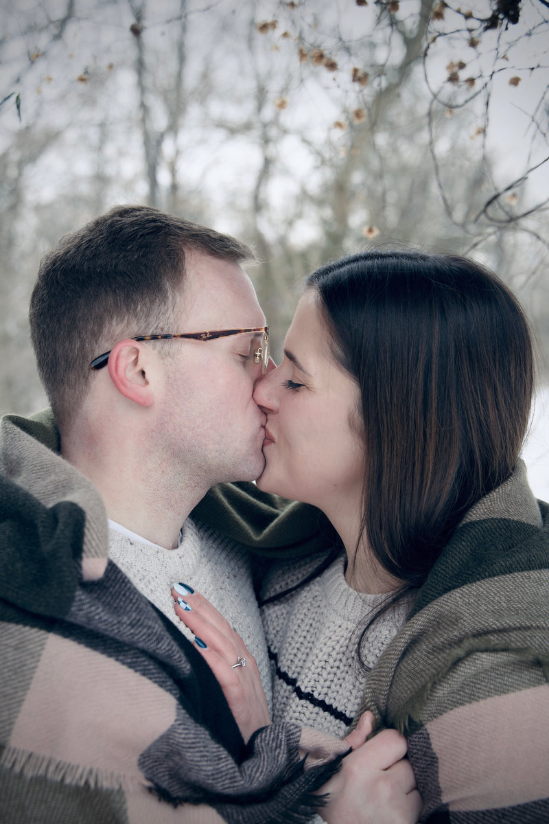 Couple kissing in a forest setting